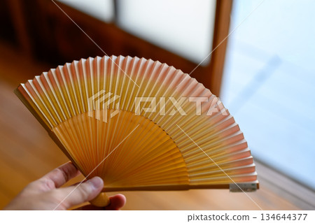 Japanese-style fan in hand Japanese-style fan in hand 134644377