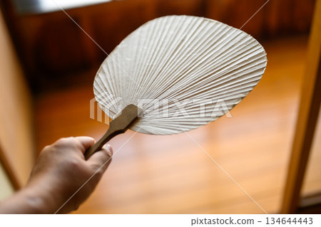 Holding a Japanese fan 134644443