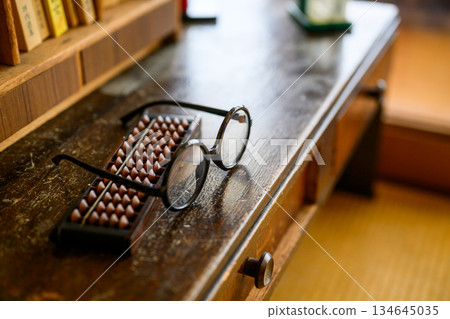 Abacus and round glasses still life 134645035