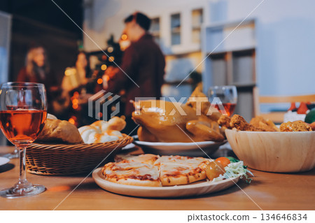 Festive Office Christmas Party with Delicious Food. A beautifully decorated office space with Christmas trees and festive lights, set up for a holiday party. 134646834