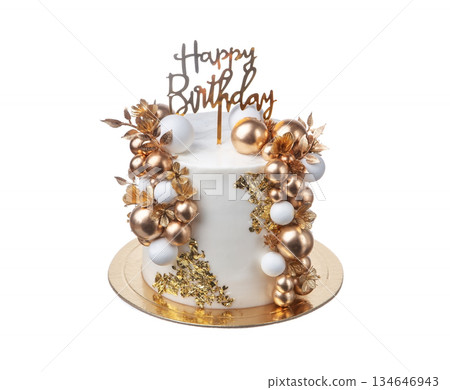 A beautifully crafted birthday cake featuring gold and white decorations, including shiny orbs and floral accents, perfect for a festive event 134646943