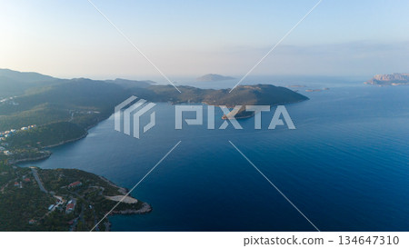 Wide aerial view of calm blue sea bay with islands and green coastline. Peaceful summer seascape with copy space. Travel, nature and vacation background. Wide aerial view of calm blue sea bay with islands and green coastline. Peaceful summer seascape with copy space. Travel, nature and vacation background. 134647310