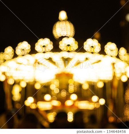 Traditional fairground carousel with glowing light bulbs Traditional fairground carousel with glowing light bulbs 134648456