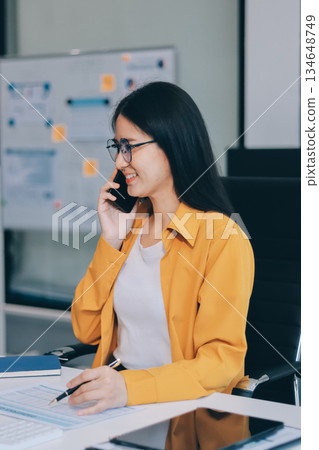 Business woman using calculator for do math finance on wooden desk in office and business working background, tax, accounting, statistics and analytic research concept. Business woman using calculator for do math finance on wooden desk in office and business working background, tax, accounting, statistics and analytic research concept. 134648749