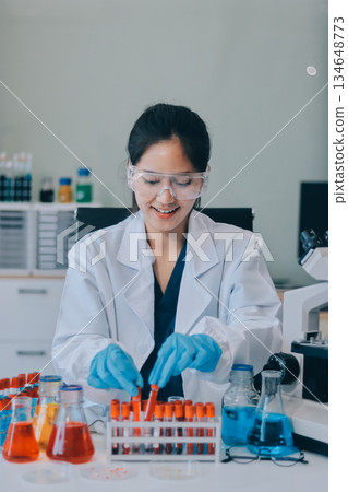 Portrait, science and happy woman on laptop in lab to research chemistry, test or innovation. Microscope, scientist and face of medical doctor in goggles for microbiology, healthcare or pharma study Portrait, science and happy woman on laptop in lab to research chemistry, test or innovation. Microscope, scientist and face of medical doctor in goggles for microbiology, healthcare or pharma study 134648773