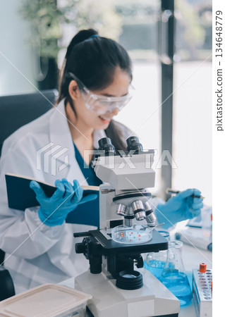 Portrait, science and happy woman on laptop in lab to research chemistry, test or innovation. Microscope, scientist and face of medical doctor in goggles for microbiology, healthcare or pharma study Portrait, science and happy woman on laptop in lab to research chemistry, test or innovation. Microscope, scientist and face of medical doctor in goggles for microbiology, healthcare or pharma study 134648779