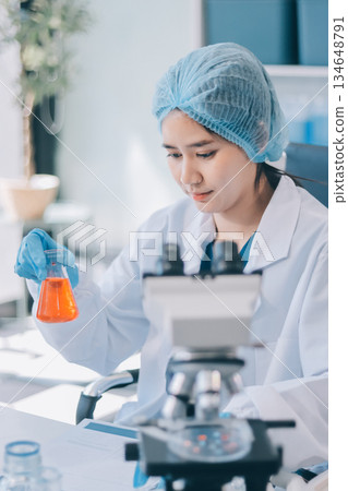 Portrait, science and happy woman on laptop in lab to research chemistry, test or innovation. Microscope, scientist and face of medical doctor in goggles for microbiology, healthcare or pharma study 134648791