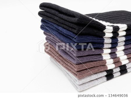 Stack of folded colorful woolen scarves on white background Stack of folded colorful woolen scarves on white background 134649036