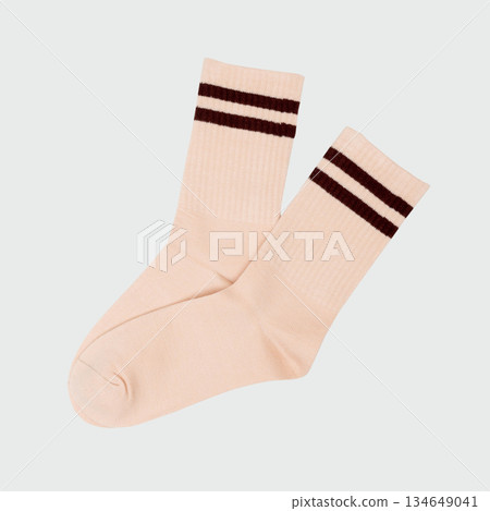 Beige crew socks with brown stripes on light gray background Beige crew socks with brown stripes on light gray background 134649041