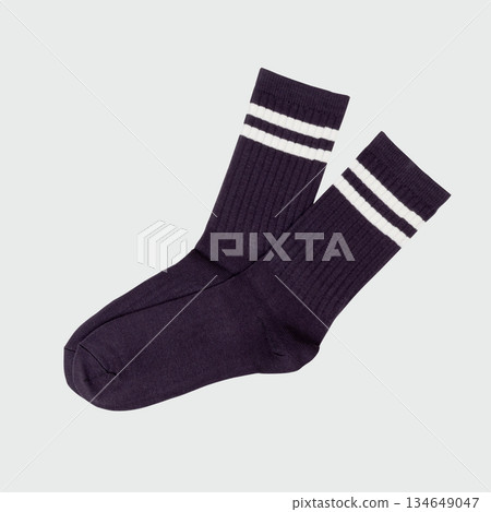 Navy blue athletic socks with white stripes on gray background 134649047
