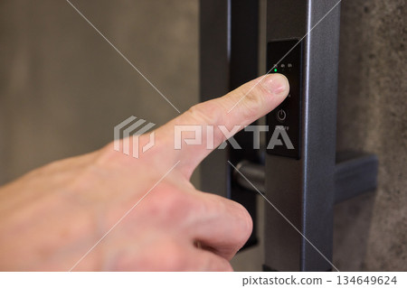A Close Up of a Finger Utilizing the Latest Modern Smart Lock Technology for Security and Access A Close Up of a Finger Utilizing the Latest Modern Smart Lock Technology for Security and Access 134649624