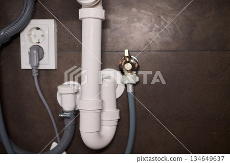 Plumbing Installation Process Under a Kitchen or Bathroom Sink Using Valves and Pipes 134649637