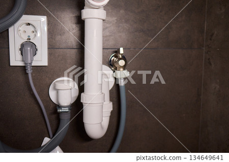 Plumbing Installation Process Under a Kitchen or Bathroom Sink Using Valves and Pipes Plumbing Installation Process Under a Kitchen or Bathroom Sink Using Valves and Pipes 134649641