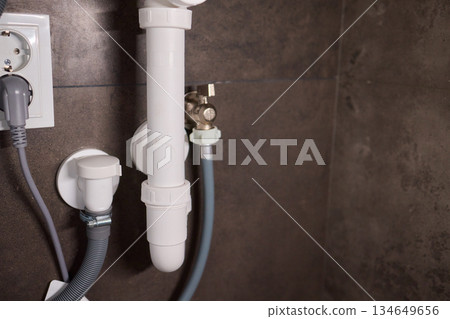 Plumbing Installation Process Under a Kitchen or Bathroom Sink Using Valves and Pipes 134649656