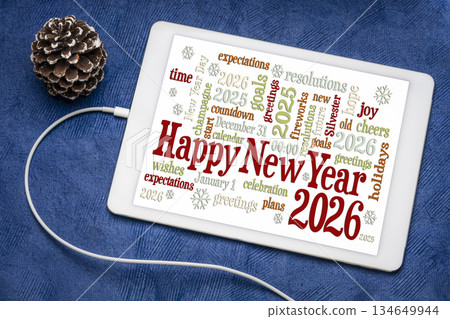 Happy New Year 2026 greetings card  - word cloud on a digital tablet with a decorative frosty pine cone 134649944