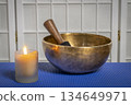 burning wax candle and Tibetan singing bowl, meditation and relaxation concept 134649971