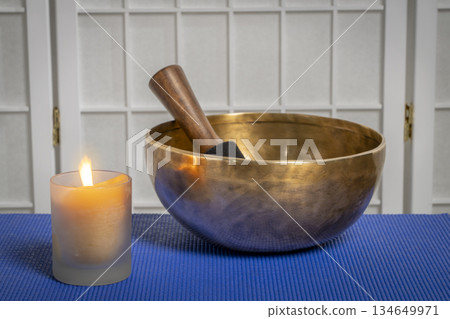 burning wax candle and Tibetan singing bowl, meditation and relaxation concept 134649971