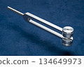 Metal weighted tuning fork used for tuning musical instruments, sound therapy, chakra healing or relaxation. 134649973