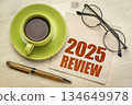 2025 year review text on a napkin with a cup of coffee, end of year business concept 134649978