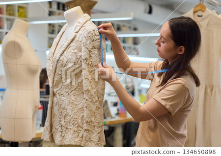 Fashion Design Tailoring a Beautiful Lace Garment on a Dress Form for Perfect Fit Fashion Design Tailoring a Beautiful Lace Garment on a Dress Form for Perfect Fit 134650898