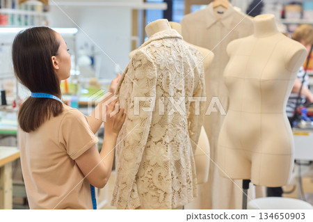 Fashion Design Tailoring a Beautiful Lace Garment on a Dress Form for Perfect Fit Fashion Design Tailoring a Beautiful Lace Garment on a Dress Form for Perfect Fit 134650903