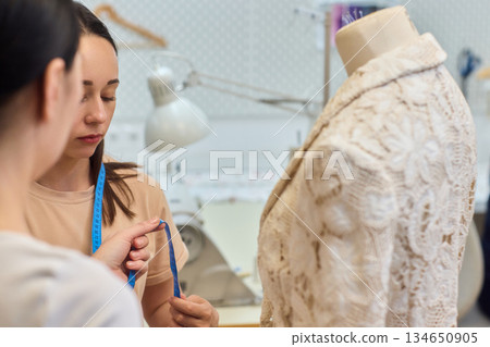 Fashion Design Tailoring a Beautiful Lace Garment on a Dress Form for Perfect Fit Fashion Design Tailoring a Beautiful Lace Garment on a Dress Form for Perfect Fit 134650905