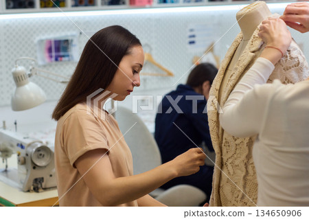 Fashion Design Tailoring a Beautiful Lace Garment on a Dress Form for Perfect Fit Fashion Design Tailoring a Beautiful Lace Garment on a Dress Form for Perfect Fit 134650906