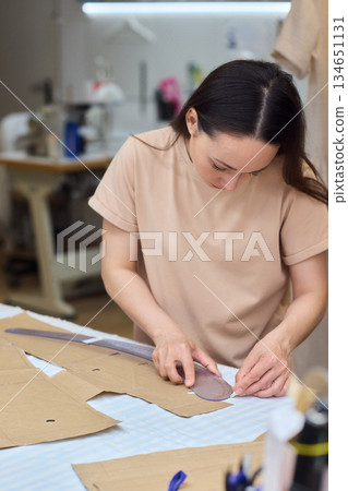 Tailoring Craftsmanship A Fashion Designer at Work Creating Beautiful Patterns with Precision 134651131