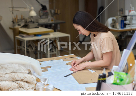 Tailoring Craftsmanship A Fashion Designer at Work Creating Beautiful Patterns with Precision 134651132