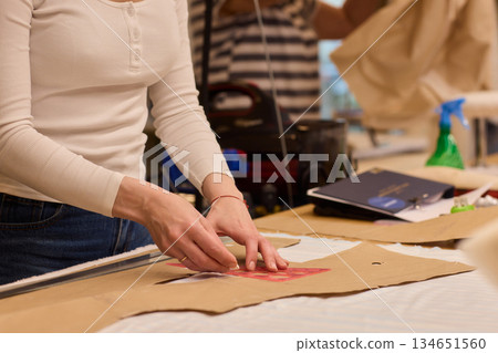 Tailoring Craftsmanship A Fashion Designer at Work Creating Beautiful Patterns with Precision 134651560