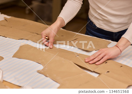 Tailoring Craftsmanship A Fashion Designer at Work Creating Beautiful Patterns with Precision Tailoring Craftsmanship A Fashion Designer at Work Creating Beautiful Patterns with Precision 134651568