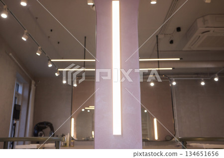 Lighting arrangement emphasizes fixtures and architectural features, Technical adjustments enhance product presentation through layered lighting and structural accents 134651656