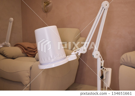 Salon lighting setup, Inviting salon space featuring adjustable lamp and soft hues, Clean and stylish pedicure area illuminated by flexible adjustable lamp with warm tones Pedicure hood Salon lighting setup, Inviting salon space featuring adjustable lamp and soft hues, Clean and stylish pedicure area illuminated by flexible adjustable lamp with warm tones Pedicure hood 134651661