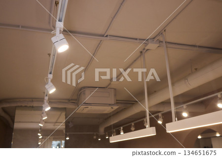 Lighting arrangement emphasizes fixtures and architectural features, Technical adjustments enhance product presentation through layered lighting and structural accents 134651675