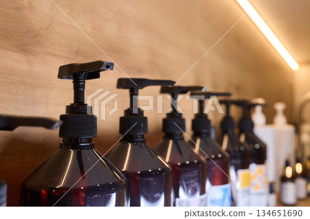 Refill station showcasing environmentally conscious container organization, Sophisticated retail or salon presentation emphasizing zero waste and natural beauty principles 134651690