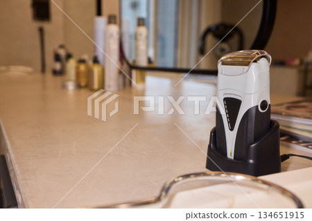 Barber tool scene, Salon station with grooming supplies, Stylish barber setup with cleaning equipment, Morning grooming station with sleek lighting and organized supplies 134651915