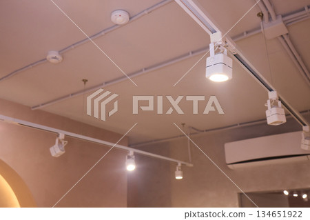 Lighting arrangement emphasizes fixtures and architectural features, Technical adjustments enhance product presentation through layered lighting and structural accents 134651922