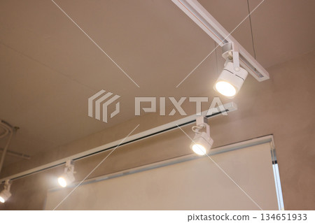 Lighting arrangement emphasizes fixtures and architectural features, Technical adjustments enhance product presentation through layered lighting and structural accents 134651933