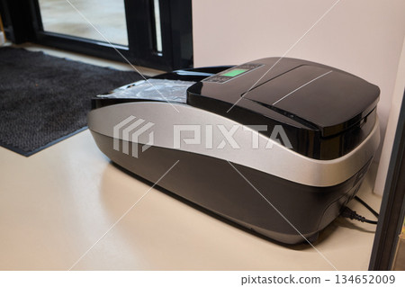 Sleek countertop device for clean foot coverings at health facilities, Efficient shoe cover dispensing unit designed for hygienic entrances in medical environments Sleek countertop device for clean foot coverings at health facilities, Efficient shoe cover dispensing unit designed for hygienic entrances in medical environments 134652009