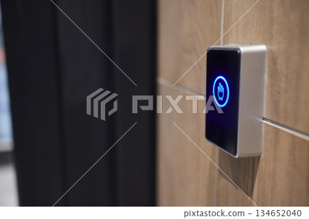 This is a modern smart touch sensor device installed on a wall, featuring a blue LED indicator 134652040
