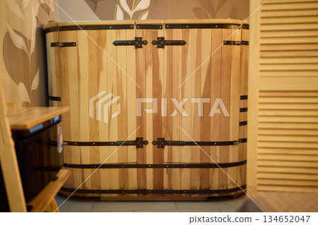Cozy sauna setting, Wooden sauna with soothing ambiance, Serene cedar sauna with gentle steam haze, Relaxing timber cabin sauna featuring warm lighting and calming 134652047