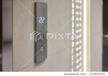 High-tech elevator panel featuring tactile buttons and illuminated screen, Advanced elevator interface showcasing touch sensitive controls alongside bright digital display screen 134652091