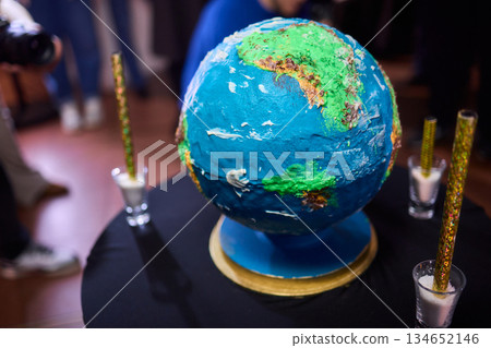 Luxurious earth themed cake showcased with sparkling fireworks and decorations, Extravagant celebration featuring world map cake illuminated with sparklers and ambient lighting Luxurious earth themed cake showcased with sparkling fireworks and decorations, Extravagant celebration featuring world map cake illuminated with sparklers and ambient lighting 134652146