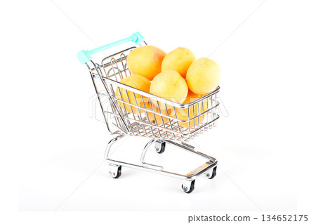 Shopping cart filled with ripe apricots Shopping cart filled with ripe apricots 134652175