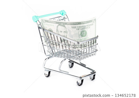 Shopping cart filled with money bills Shopping cart filled with money bills 134652178