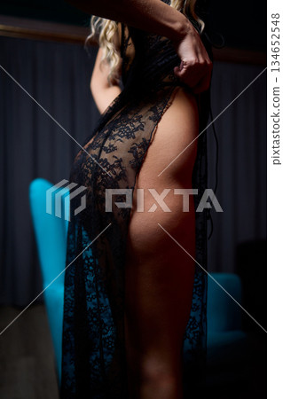 Tranquil evening atmosphere featuring slender figure resting peacefully, Soothing nighttime setting depicting relaxed person with graceful form under soft lighting 134652548