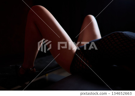 Tranquil evening atmosphere featuring slender figure resting peacefully, Soothing nighttime setting depicting relaxed person with graceful form under soft lighting Tranquil evening atmosphere featuring slender figure resting peacefully, Soothing nighttime setting depicting relaxed person with graceful form under soft lighting 134652663