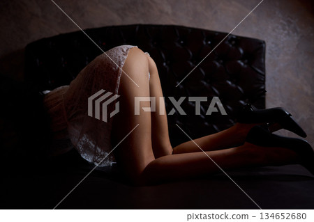 Sensual studio photograph highlighting elegant lingerie and confident posture, Artistic portrayal of provocative fashion in softly lit setting emphasizing charm and allure Sensual studio photograph highlighting elegant lingerie and confident posture, Artistic portrayal of provocative fashion in softly lit setting emphasizing charm and allure 134652680