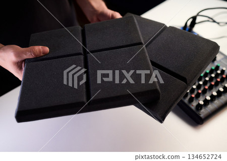 Recording environment with soundproof features, Professional sound studio with acoustic treatments in place, Closeup of soundproofing and equipment in home studio setting Recording environment with soundproof features, Professional sound studio with acoustic treatments in place, Closeup of soundproofing and equipment in home studio setting 134652724