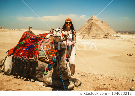 Woman And Traditional Camel At The Pyramids Woman And Traditional Camel At The Pyramids 134653212